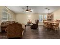 Open floor plan with a dining table and living room with hardwood floors at 215 N Power Rd # 21, Mesa, AZ 85205