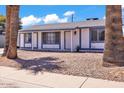 Charming single-story home with a white exterior and blue trim, offering great curb appeal at 2207 W Bentrup St, Chandler, AZ 85224