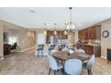 Open-concept kitchen and dining area featuring tile floors, a large island, and stainless steel appliances at 22353 N 99Th Ln, Peoria, AZ 85383