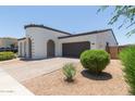 Single-Gathering home featuring a dark two-car garage, desert landscaping, and covered porch entry at 22853 E Calle Luna --, Queen Creek, AZ 85142