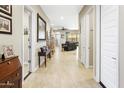 Bright hallway with multiple doors leading to different rooms and elegant decor at 24847 N 175Th Dr, Surprise, AZ 85387
