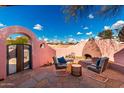 A covered courtyard features a stone fireplace and seating area at 2843 E Captain Dreyfus Ave, Phoenix, AZ 85032