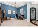 Office space with blue walls, desk, chandelier, and iron accented doorway at 3229 E Mountain Village Cir, Phoenix, AZ 85042