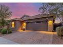 Home exterior featuring a brick paver driveway and desert landscaping at 4152 W Bradshaw Creek Ln, New River, AZ 85087