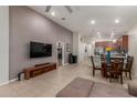 Open-concept living area featuring high ceilings, a ceiling fan, and tile floors at 4152 W Bradshaw Creek Ln, New River, AZ 85087