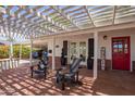 Inviting covered patio with comfortable seating, a red front door, and ample space for relaxation at 4238 E Mitchell Dr, Phoenix, AZ 85018