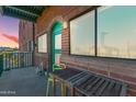 Balcony featuring brick exterior, outdoor seating, and lantern, creating an inviting space with natural light at 424 S 2Nd St # 203, Phoenix, AZ 85004