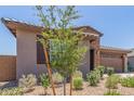 Single-Gathering house featuring a gravel yard with drought-resistant plants and a two-car garage at 4371 E Enmark Dr, San Tan Valley, AZ 85143