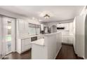 Open kitchen with white cabinetry, stainless steel appliances, and sliding glass door to the outdoor area at 4419 W Vogel Ave, Glendale, AZ 85302