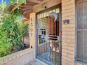Inviting entryway with custom iron security door with desert theme and brick surround, adding charm and character at 4509 E Joan De Arc Ave, Phoenix, AZ 85032