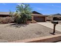 A well-landscaped front yard featuring drought-resistant plants, offering an inviting curb appeal to this charming home at 4509 E Joan De Arc Ave, Phoenix, AZ 85032