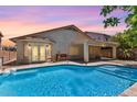 Sparkling backyard pool with covered patio and lush landscaping at 45131 W Horse Mesa Rd, Maricopa, AZ 85139