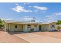 Lovely single-story house with a covered patio, desert landscaping, and a spacious driveway at 5309 E Butte St, Mesa, AZ 85205