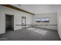Bright bedroom with large windows and closet, offering comfort and style at 53925 W Stallion Rd, Maricopa, AZ 85139