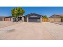 Lovely single-story home with modern garage door, xeriscaped front yard, and mature desert landscaping at 6719 S Hardy Dr, Tempe, AZ 85283