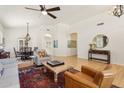 Light-filled living room featuring hardwood floors, stylish decor and views to dining room at 7032 N 2Nd Ave, Phoenix, AZ 85021