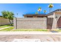 A charming home is adorned with decorative cinder block and a gated wooden fence entry, enhancing curb appeal at 830 S Dobson Rd # 86, Mesa, AZ 85202