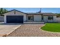 Charming single-story home with well-maintained lawn, desert landscaping, and attached two car garage at 8602 N 42Nd Dr, Phoenix, AZ 85051