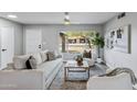 Bright living room featuring neutral-toned furniture, a large window, and modern décor at 1119 W Ellis Dr, Tempe, AZ 85282