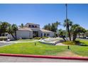 The clubhouse features a fountain, palm trees, and a well-manicured green lawn at 11375 E Sahuaro Dr # 1055, Scottsdale, AZ 85259