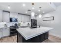 Bright kitchen with quartz countertops, white cabinetry, stainless steel appliances, and modern pendant lighting at 120 E Rio Salado Pkwy # 101, Tempe, AZ 85281