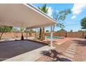 Covered backyard patio with a concrete slab leading to a refreshing pool surrounded by landscaping at 1238 E Cambridge Ave, Phoenix, AZ 85006