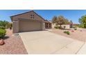 Well-kept home with a two-car garage, a long driveway, and desert landscaping for low maintenance at 15874 W Wildflower Dr, Surprise, AZ 85374