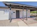 Close up of home's front door, desert landscaping and shaded parking at 1616 E Pecan Rd, Phoenix, AZ 85040