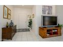 Inviting entryway features neutral-toned walls, tile flooring, and tasteful décor, complete with furniture, artwork, and plants at 16354 W Labyrinth Ln, Surprise, AZ 85374