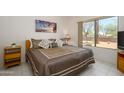 Comfortable main bedroom with neutral decor, a large window, and a well-made bed with plenty of pillows at 16354 W Labyrinth Ln, Surprise, AZ 85374