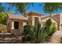 Inviting single-story home with a tile roof and attractive desert landscaping at 17493 N Costa Brava Ave, Maricopa, AZ 85139