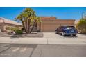 Exterior of the home showing a three-car garage and desert landscaping, with a car parked in the driveway at 1751 W Mulberry Dr, Chandler, AZ 85286