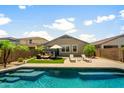 Backyard oasis featuring a refreshing pool, lounge chairs, lush landscaping and patio furniture for relaxation and enjoyment at 1812 E Parkside E Ln, Phoenix, AZ 85024