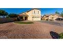 Inviting two-story home featuring a manicured lawn, charming front porch, and attached two-car garage at 1918 E Megan St, Gilbert, AZ 85295