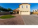Inviting two-story home featuring a manicured lawn, charming front porch, and attached two-car garage at 1918 E Megan St, Gilbert, AZ 85295
