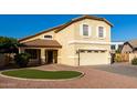 Inviting two-story home featuring a manicured lawn, charming front porch, and attached two-car garage at 1918 E Megan St, Gilbert, AZ 85295