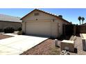 View of a single Gathering home featuring a two-car garage, desert landscaping, and a neutral color scheme at 3027 W Zachary Dr, Phoenix, AZ 85027
