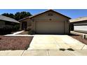 Charming single-story home with a two-car garage, desert landscaping, and a well-maintained front yard at 3027 W Zachary Dr, Phoenix, AZ 85027