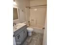 Bathroom featuring a shower-tub combo, a newer-style toilet and single sink vanity at 3329 W Ross W Ave, Phoenix, AZ 85027