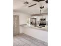 Open kitchen with stainless steel appliances, white cabinets, and breakfast bar seating at 3329 W Ross W Ave, Phoenix, AZ 85027