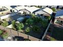 Aerial view of backyard featuring a large grassy area, privacy fence and mature trees at 3404 E Lavey Ln, Phoenix, AZ 85032