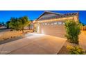 Single story home featuring a two-car garage and low maintenance desert landscaping at 3404 E Lavey Ln, Phoenix, AZ 85032