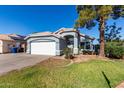 Charming single-story home featuring a well-manicured lawn and a two-car garage at 403 N Monte Vista St, Chandler, AZ 85225