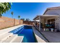 Backyard pool offers a refreshing escape, complemented by the surrounding patio and landscaping at 403 N Monte Vista St, Chandler, AZ 85225