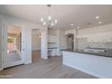 Bright kitchen with stainless steel sink, white cabinets and granite counters at 5434 W T Ryan Ln, Laveen, AZ 85339