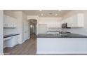 Bright kitchen with stainless steel appliances, granite counters, and a breakfast bar at 5434 W T Ryan Ln, Laveen, AZ 85339