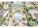 An aerial view of the home featuring a swimming pool, and well-manicured desert landscaping at 6302 E Turquoise Ave, Paradise Valley, AZ 85253