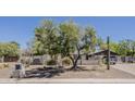 Beautiful home featuring desert landscape, a mature shade tree, and a block fence for added privacy at 6302 E Turquoise Ave, Paradise Valley, AZ 85253