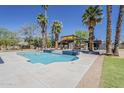 Outdoor pool featuring palm trees, cabana, modern design, and a well-manicured lawn at 6302 E Turquoise Ave, Paradise Valley, AZ 85253