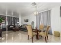 Spacious living room and dining area featuring modern chandelier and neutral tones at 6846 S 26Th Pl, Phoenix, AZ 85042